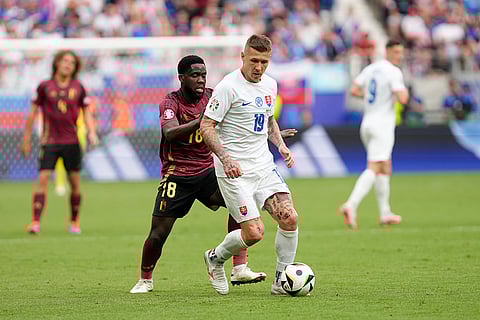 Juraj Kucka (19) is defended by Belgium's Orel Mangala
